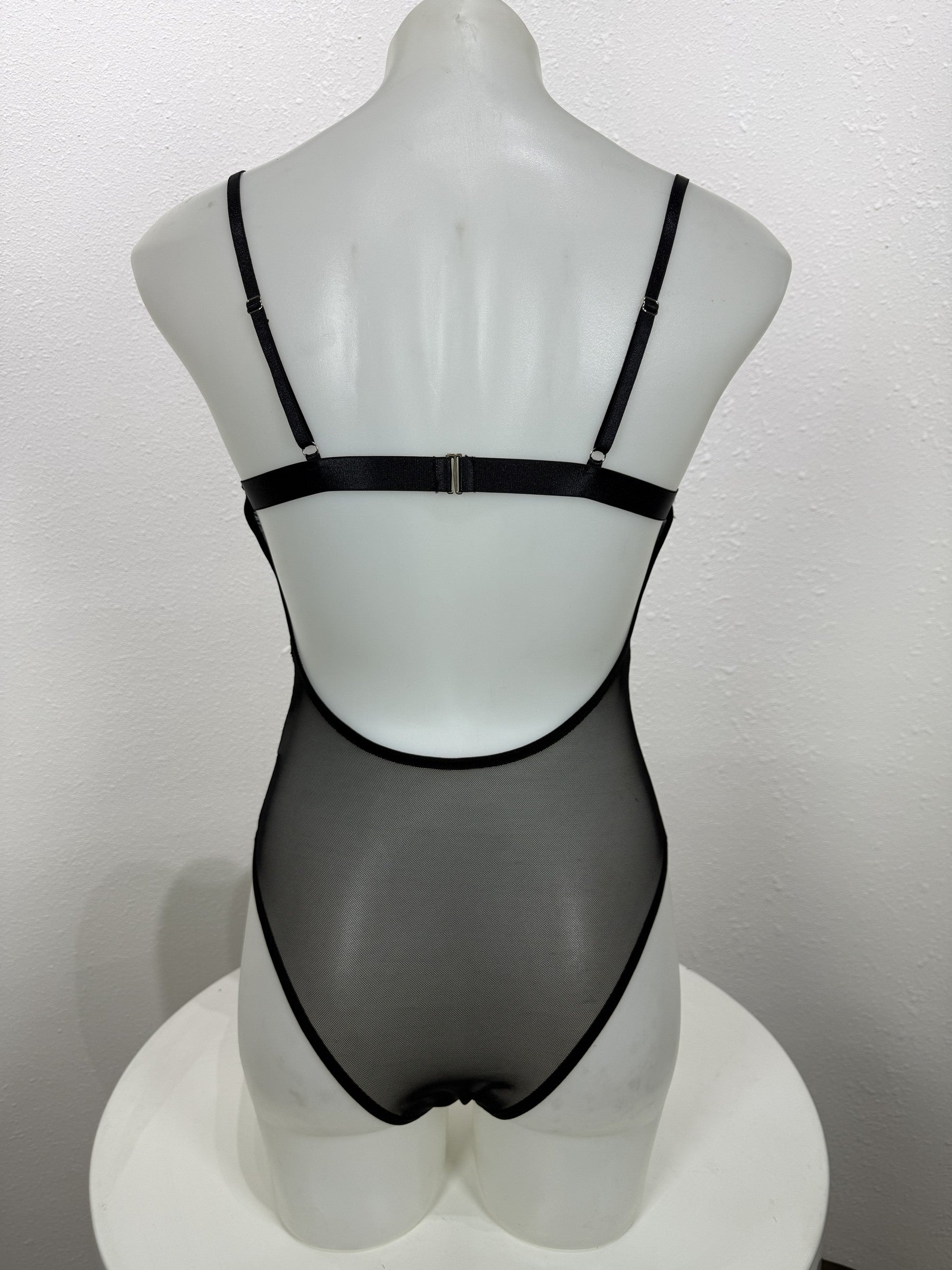 Back view of the Nightshade black lace bodysuit on a mannequin.